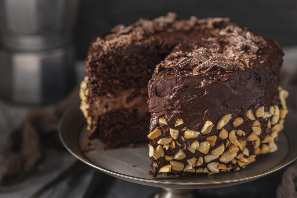 Frosting a chocolate cake with whipped ganache.
