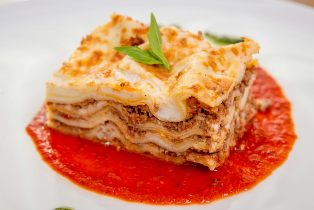 Overhead shot of lasagna served with garlic bread and salad