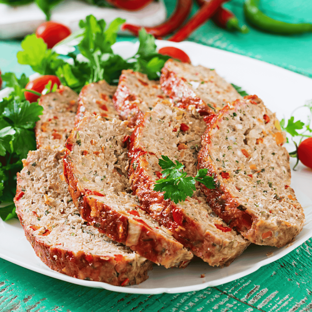 american-food-homemade-ground-beef-meatloaf-with-ketchup-bell-peppers-meat-loaf-white-plate