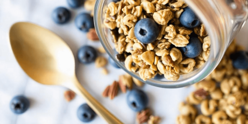 A bowl of homemade granola with yogurt and fresh berries