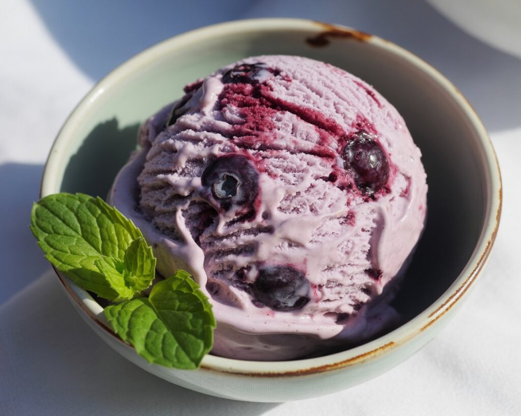 Freshly made blueberry ice cream with vibrant purple color on table