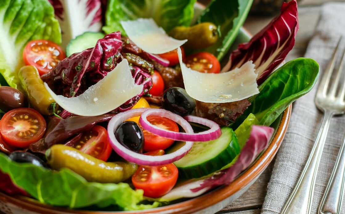 Fresh Italian salad with tomatoes, mozzarella, and basil on a plate.