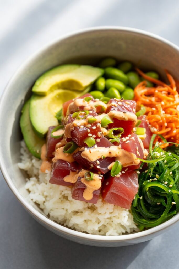 Homemade poke bowl served in a rustic wooden bowl on a table.