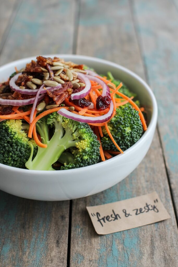 Close-up of creamy broccoli salad with crunchy textures.