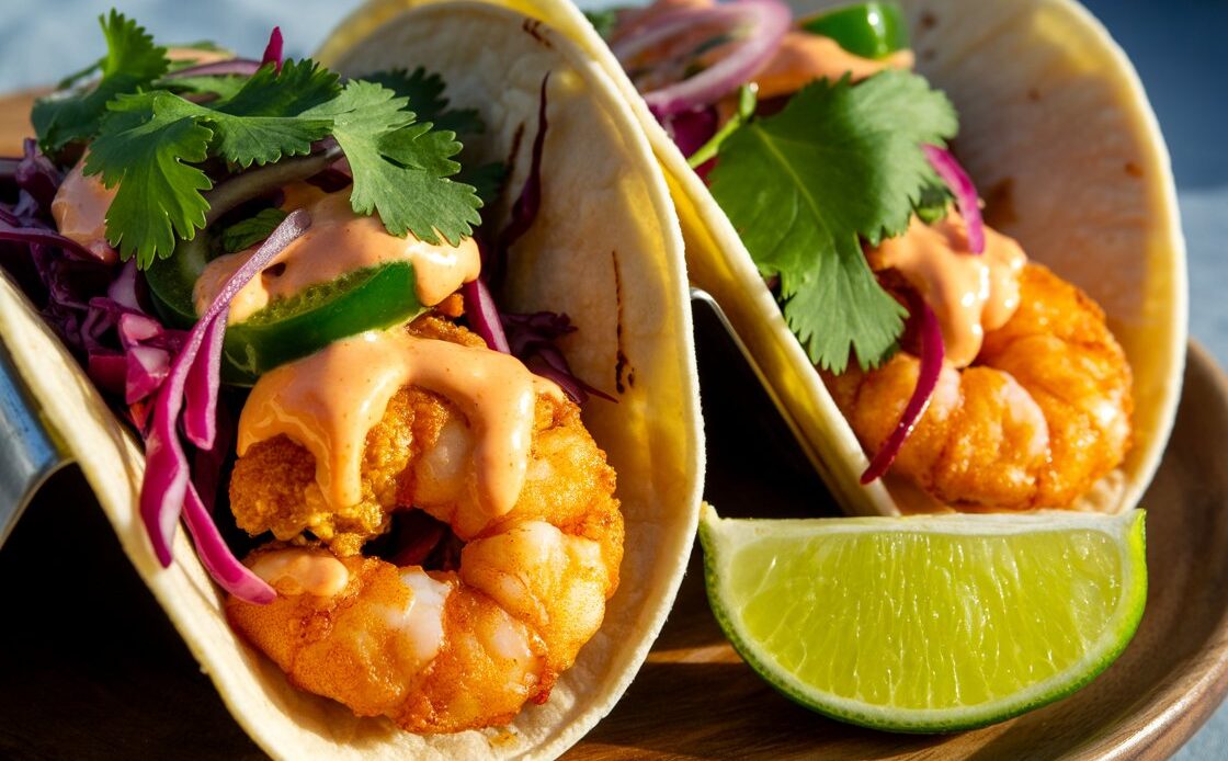 Homemade shrimp tacos filled with crunchy slaw and spicy mayo.